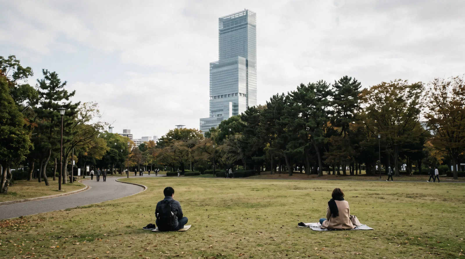 The lawn and cafes between the station and the zoo gate at 09:20 with the tower blocks behind, Tennoji Osaka Japan