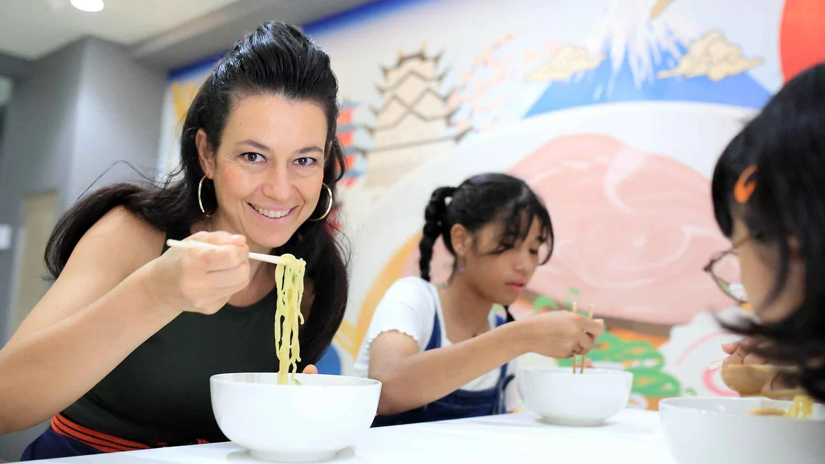 Fresh ramen noodles being cut at a cooking studio near Osaka Castle, Osaka Japan