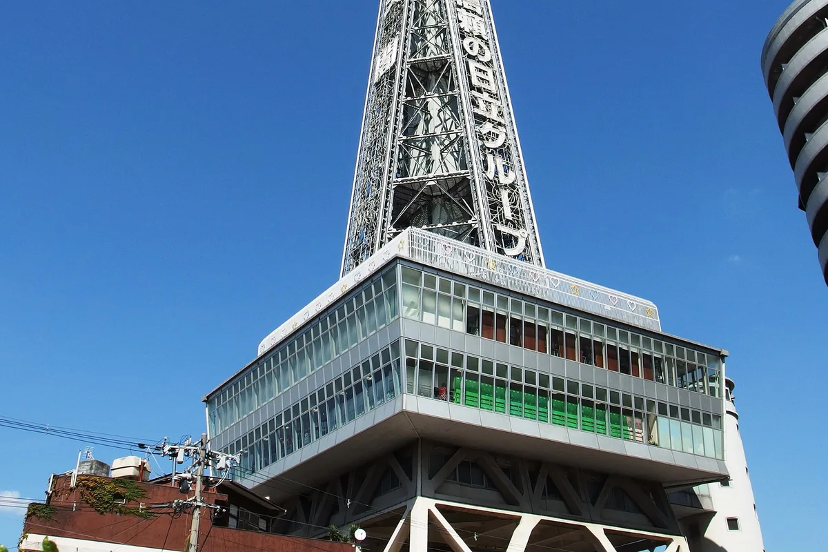 The steel frame of Tsutenkaku tower above the Shinsekai streets, Osaka, Japan